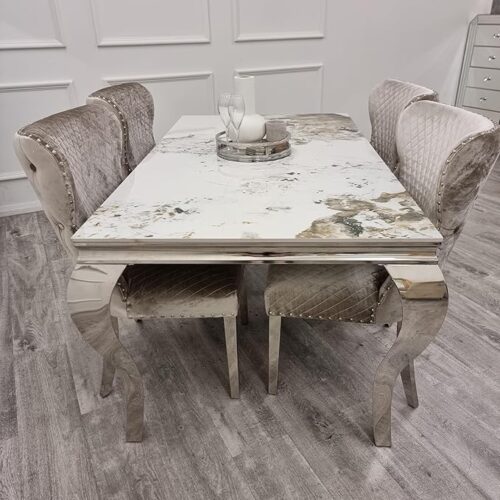 Cream coloured Dining table and silver velet chairs set in an open room